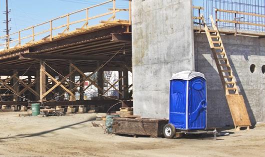 rows of portable toilets at a work site, providing essential amenities for workers